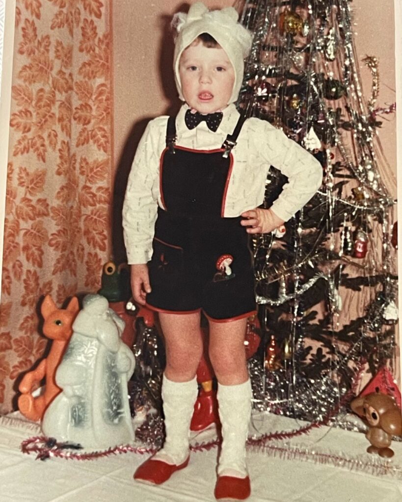 boy performace Christmas tree in front